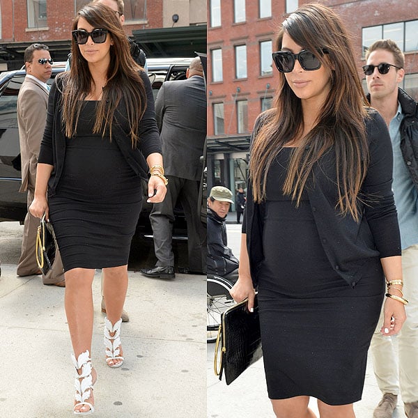 Kim Kardashian contrasted the stark white sandals with a fitted black dress, a black cardi, big black sunglasses, and a black croc-embossed clutch