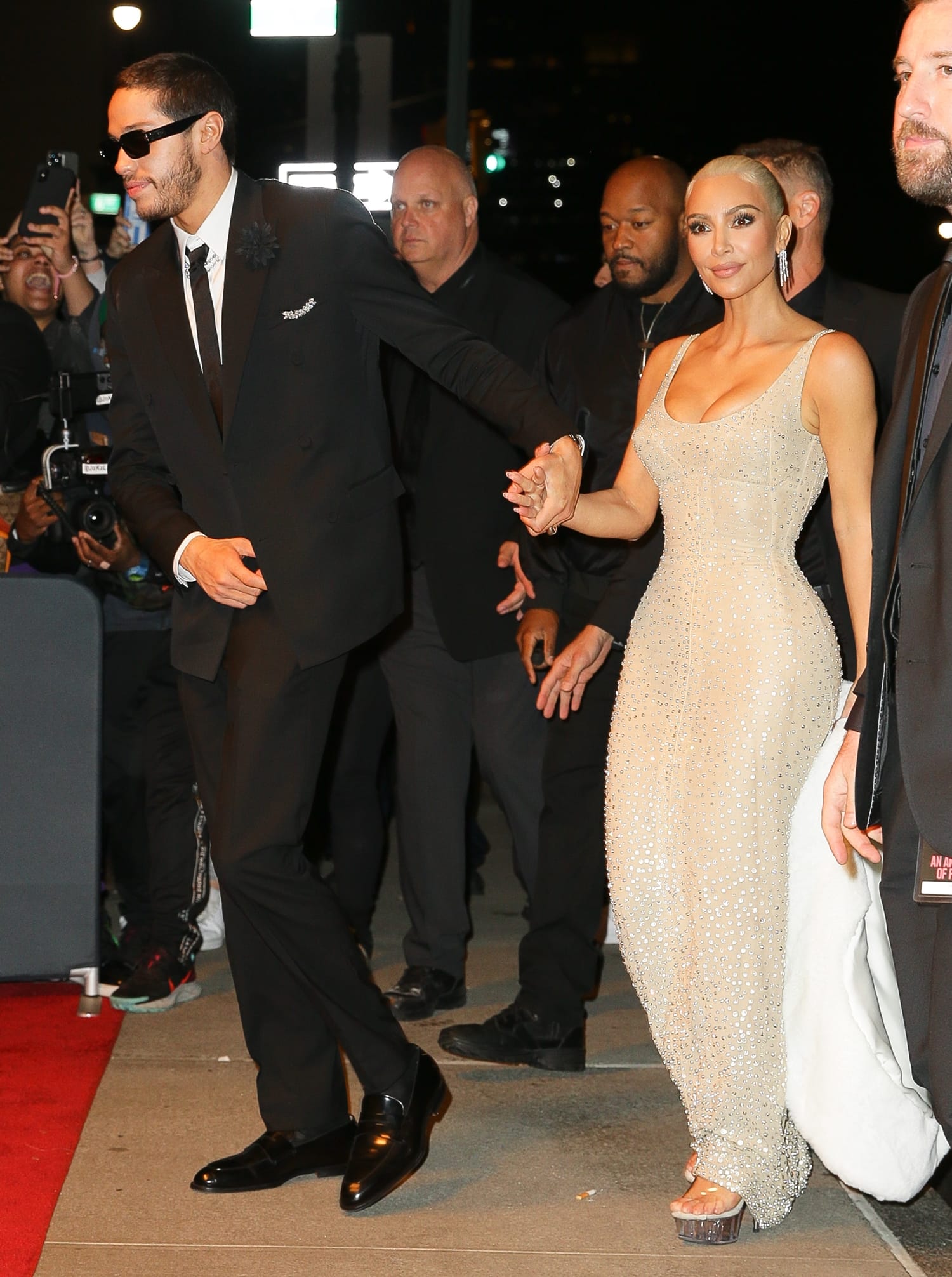 Kim Kardashian and Pete Davidson hold hands while arriving back at their Ritz-Carlton Hotel after attending the Met Gala