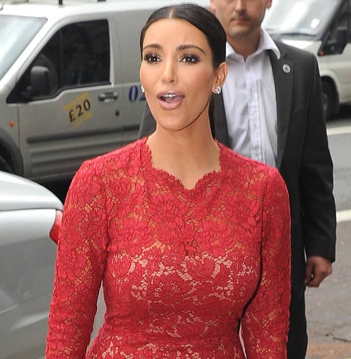 Kim Kardashian makes a chic arrival at her hotel in London, England, showcasing the same stunning Valentino red lace dress