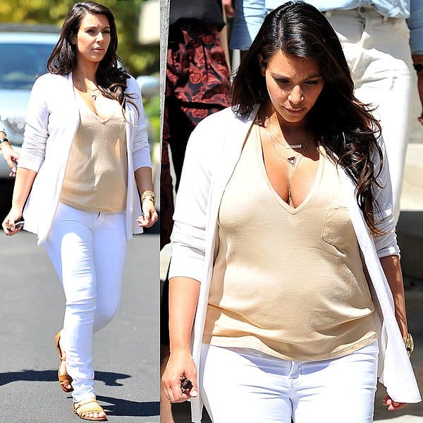 Kim Kardashian radiantly embraces motherhood in stylish white maternity jeans during a casual outing