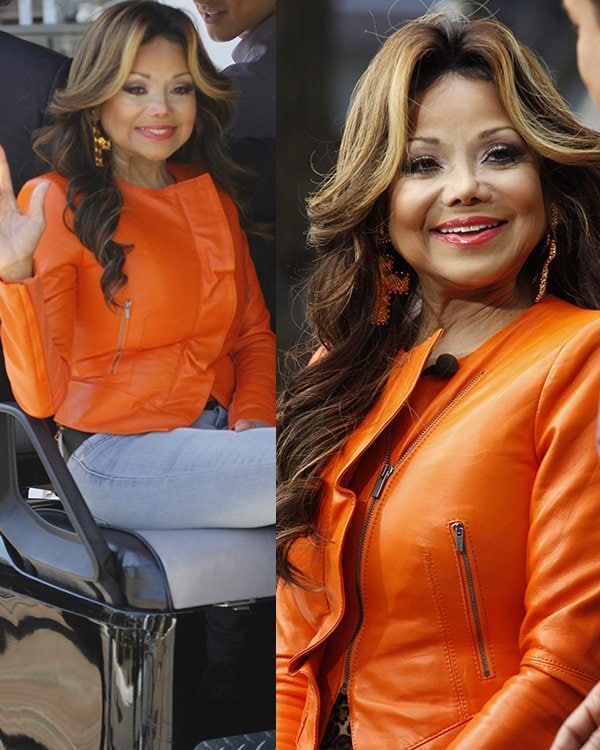 La Toya Jackson radiates in a vibrant orange leather jacket at The Grove, making a splash on 'Extra' with host Mario Lopez, April 16, 2013