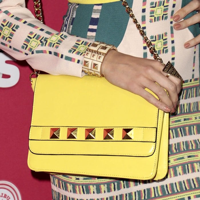 Louise Roe toting a studded yellow purse