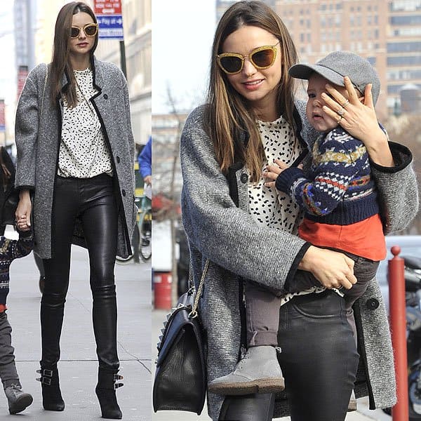 Miranda Kerr rocked a stylish New York look featuring an Isabel Marant Khan tweed coat, Miu Miu yellow glitter sunglasses, a Valentino studded shoulder bag, a Bvlgari B.Zero1 ring, Helmut Lang skinny leather pants, and Barbara Bui pointed-toe ankle boots