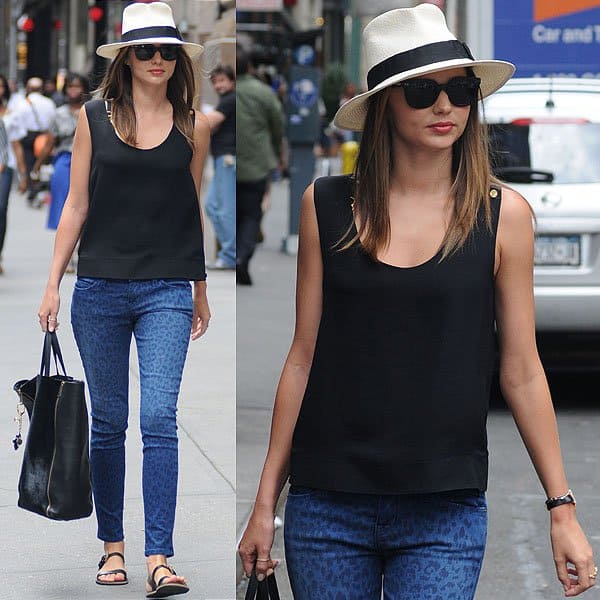 Miranda Kerr sported a chic summer look in New York City wearing a The Row Gordon silk top and Current/Elliott leopard print pants, accessorized with a Bvlgari B.Zero1 ring, Celine tote, Flint sunglasses, a Louis Vuitton bag charm, a Scosha bracelet, and Acne leather sandals