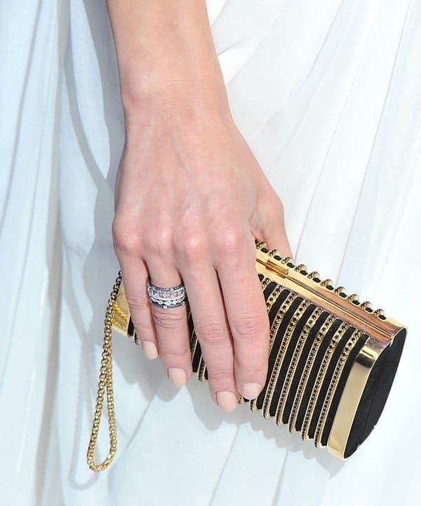 Olga Kurylenko toted a black-and-gold Stark 'Seductress' Swarovski crystal clutch