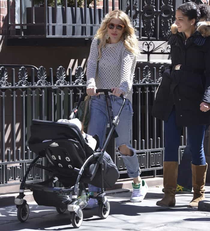 In New York City on April 6, 2013, Sienna Miller was seen wearing a Paper Denim & Cloth Lexington sweater, Eze skinny slouch jeans in Ripper, and carrying a Stella McCartney python print bag