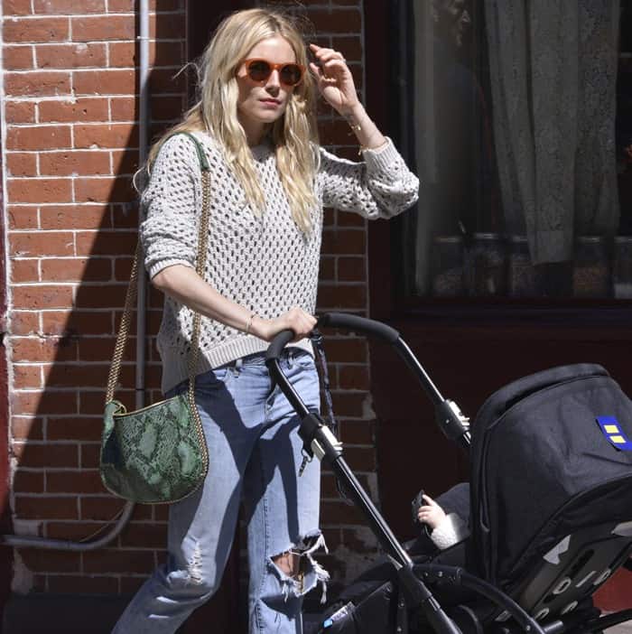 Sienna Miller enjoys a stroll in New York's West Village, showcasing how to wear casual knits and denim with a touch of elegance