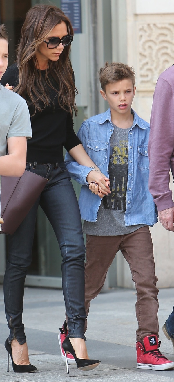 Victoria Beckham and her son Romeo James are seen leaving the 'NIKE' store on the Champs-Elysees Avenue