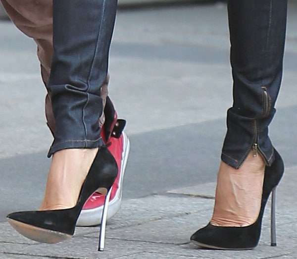 Victoria Beckham wearing ultra-high silver-heeled pumps