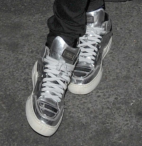 British model Cara Delevingne finished her all-black ensemble with shiny sneakers