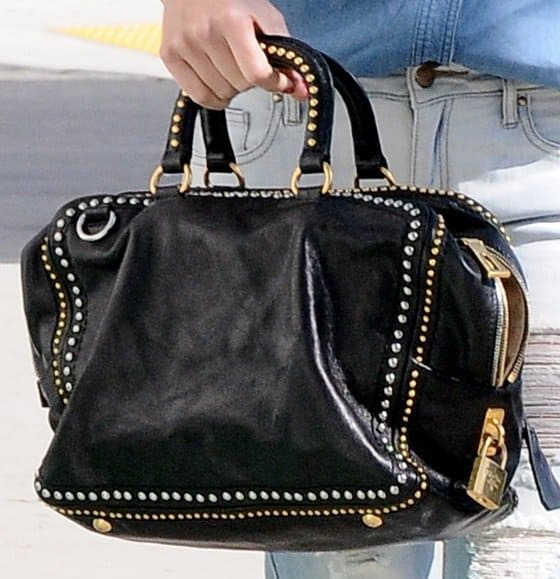 Exclusive Detail Shot: Dive into the elegance of Miranda Kerr's timeless Prada studded medium tote, a testament to enduring luxury and style