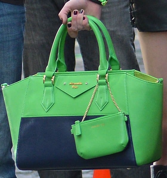 Taylor Momsen's unexpected twist: A bright green color-block handbag adds a pop of color to her all-black ensemble