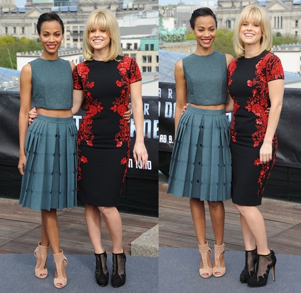 Zoe Saldaña stuns in a modern, midriff-baring Calvin Klein Collection outfit paired with Jimmy Choo sandals, while Alice Eve looks elegant in a floral-accented Reem Acra dress complemented by Bionda Castana ankle boots at the Star Trek Into Darkness Berlin photo call