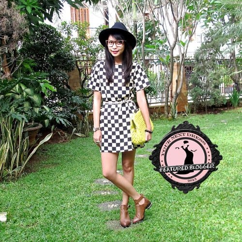 Adelle cinched her checkered dress at the waist to give it more form