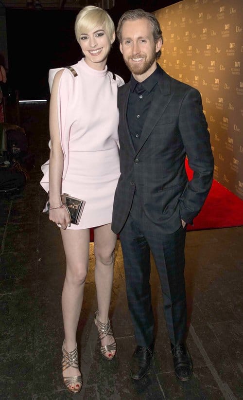 Anne Hathaway alongside her husband Adam Shulman, radiating joy at a public appearance, 2013