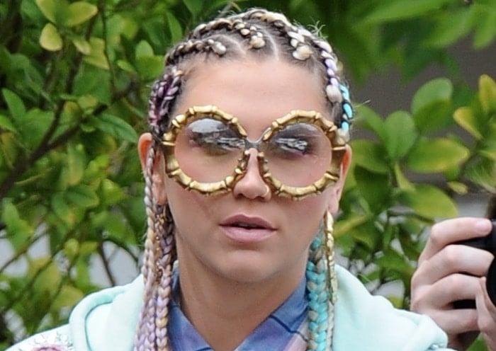 Ke$ha accessorized with cornrow braids and bug-eye sunnies
