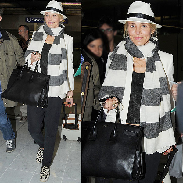 Cameron Diaz makes a stylish arrival at Nice Airport in France, donning a cool fedora and her go-to striped scarf, proving animal prints can be worn effortlessly on May 25, 2013