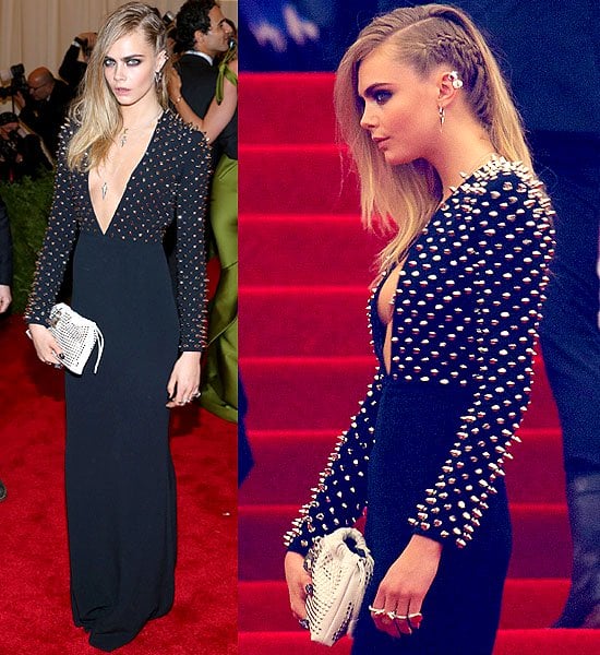 Cara Delevingne dazzled in a studded navy Burberry dress with a plunging neckline, complemented by a part-braided hairstyle and a matching studded clutch, making her one of the standout attendees at the Costume Institute Gala for the "PUNK: Chaos to Couture" exhibition at the Metropolitan Museum of Art