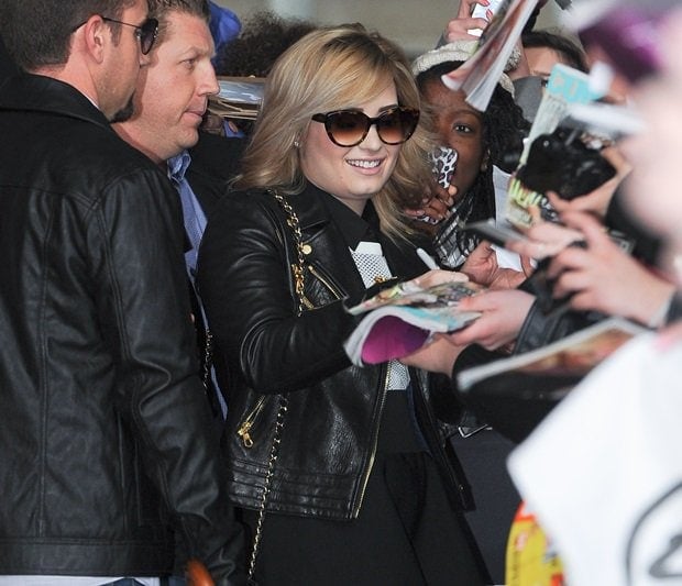 Demi Lovato greeted by adoring fans at BBC Radio 1 in London, showcasing her new blonde hair and chic black outfit, May 29, 2013