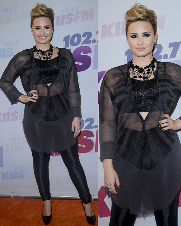 Demi Lovato embraces edgy elegance in a sheer black tunic layered over a sequined bustier and fitted Topshop leggings, finishing the look with studded Saint Laurent 'Janis Clous Escarpin' pumps