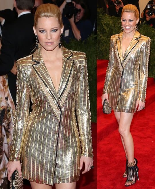 Elizabeth Banks steals the show in an Atelier Versace glittery gold tuxedo jacket and a chic studded clutch