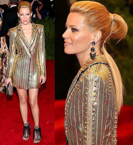 Elizabeth Banks dazzles in a golden chainmail jacket by Atelier Versace, a standout look at the Met Gala 2013