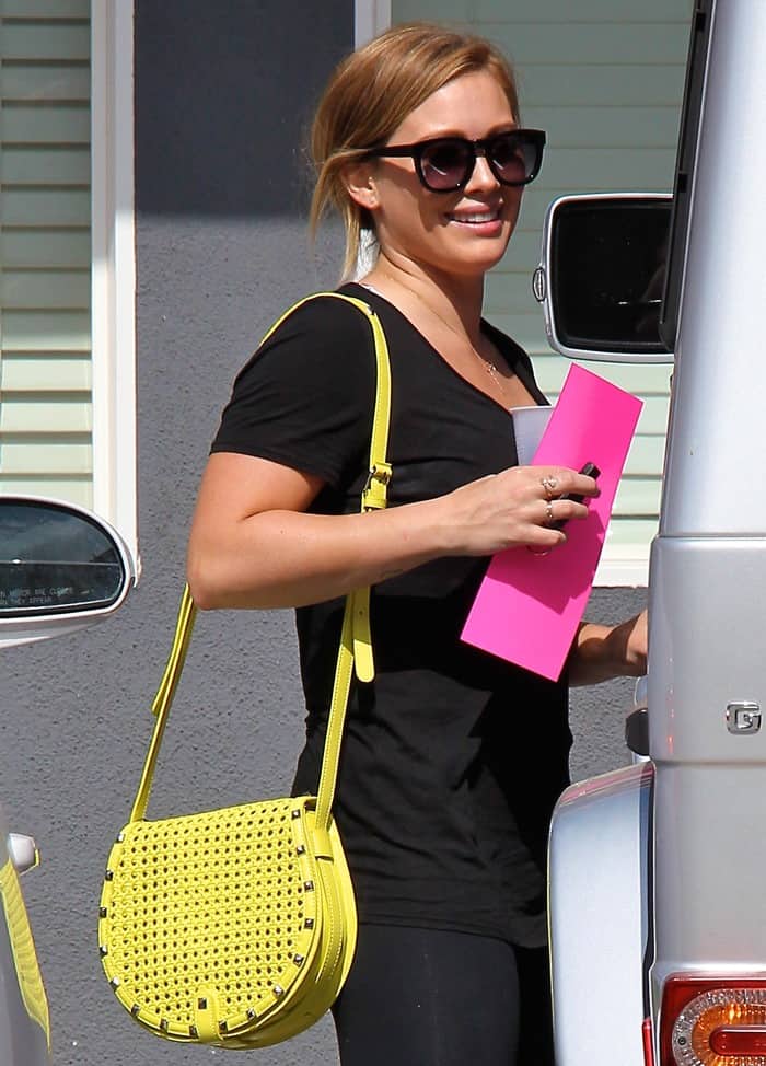 Hilary Duff exits a Pilates session in Los Angeles, radiant with a sunny Rebecca Minkoff 'Skylar' bag, showcasing her effortless post-workout glow, May 24, 2013