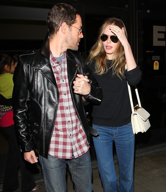 Kate Bosworth effortlessly pairs a chic black sweater with trendy Mother flare jeans