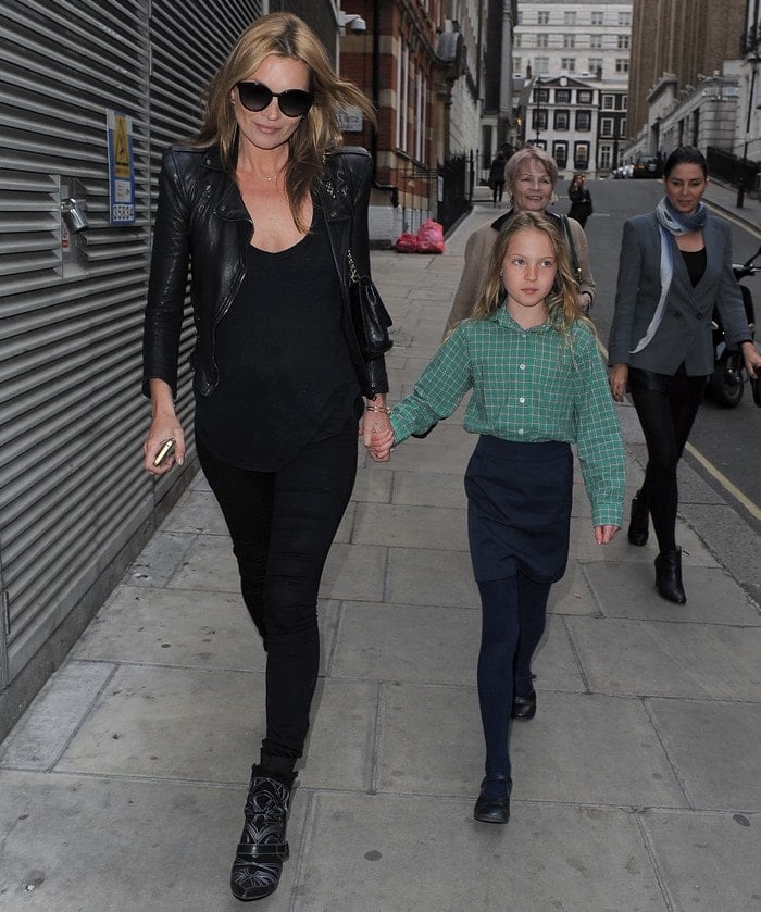 Kate Moss wearing embroidered boots with black jeans, a casual tee, and a cropped leather jacket