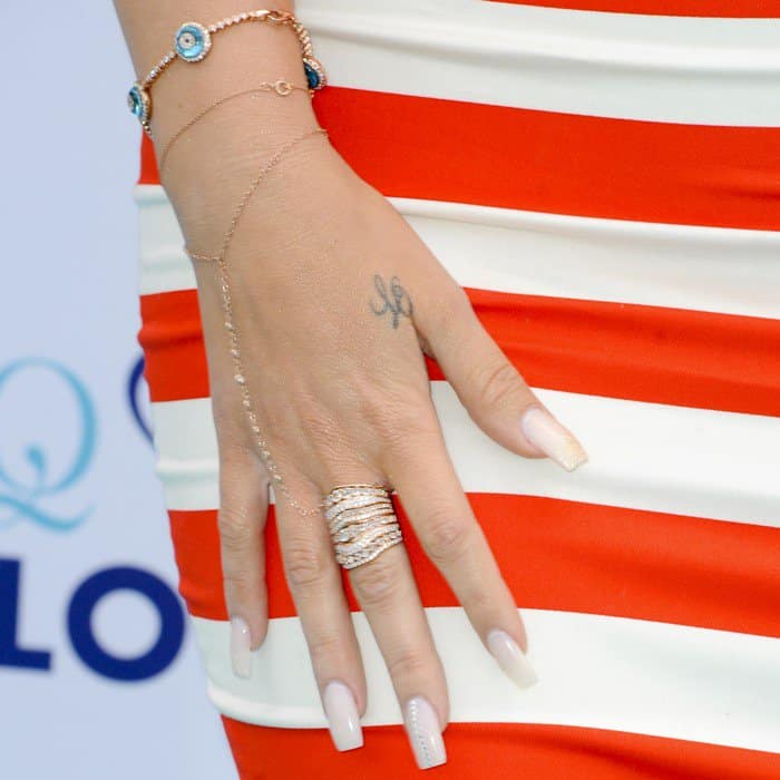 Khloé Kardashian showcasing her elegant jewelry at the Glam Louder event