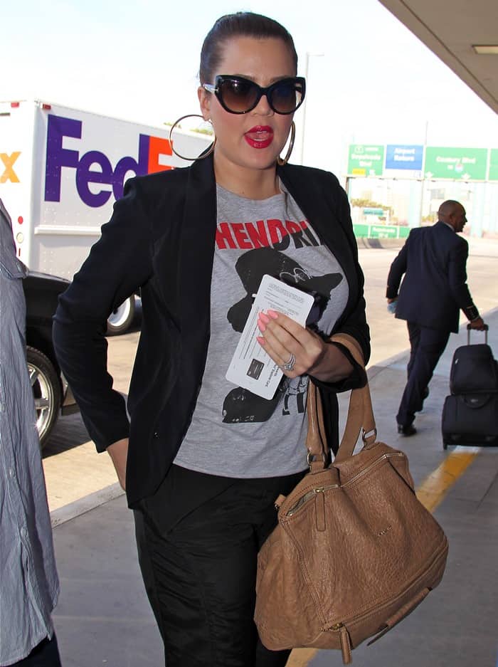 Khloe Kardashian seen arriving at LAX airport in Los Angeles, effortlessly blending casual style with a hint of luxury on May 3, 2013