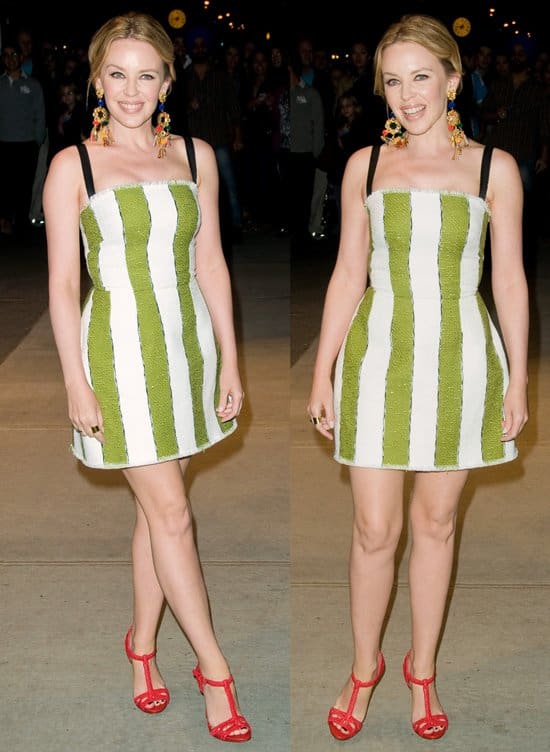 Kylie Minogue radiates in a green-and-white striped, strapless Dolce & Gabbana dress from the Spring 2013 Ready-to-Wear collection, paired with bold red sandals