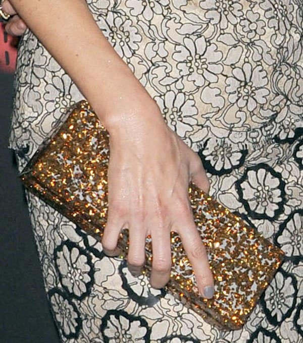 Lake Bell accessorizes with a glittery gold Edie Parker clutch at the 'Black Rock' Hollywood premiere