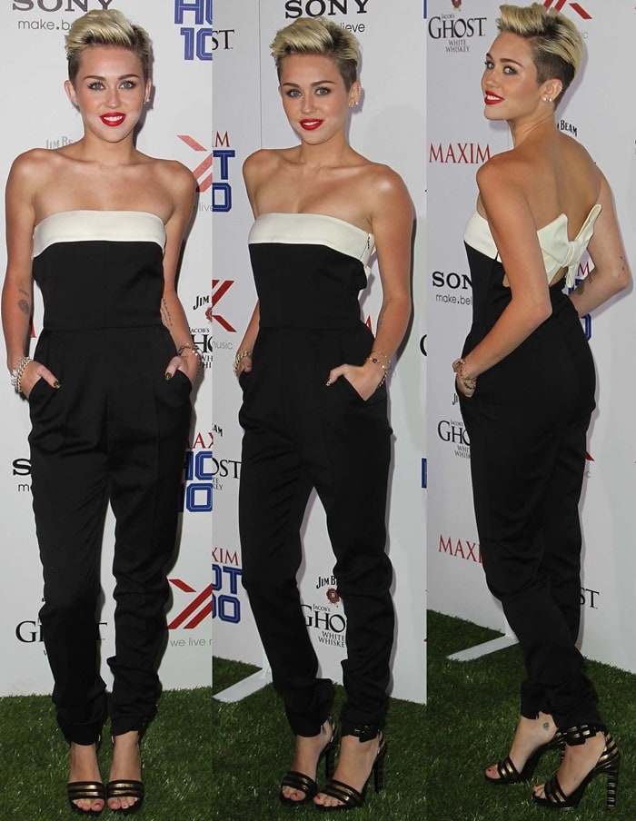 Miley Cyrus in a black strapless jumpsuit and cuff sandals in black and gold stripes