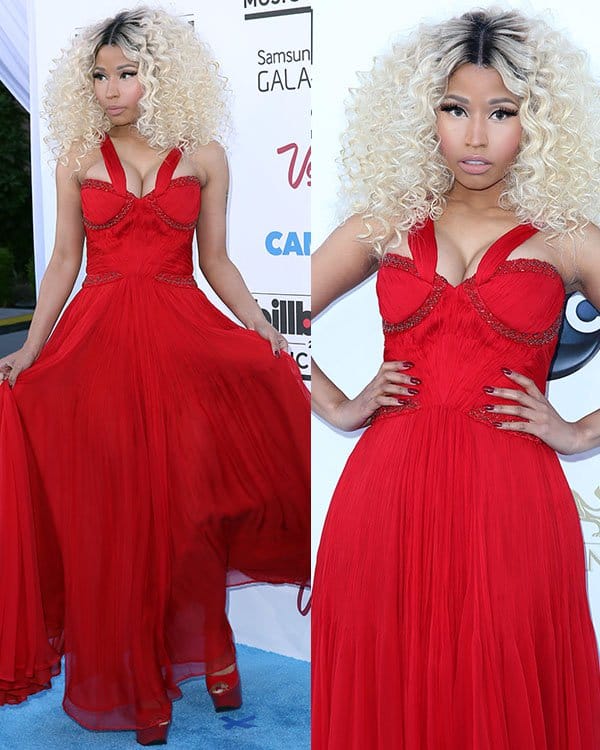 Nicki Minaj stuns in a bold, flowing red gown with intricate detailing, exuding timeless elegance at the 2013 Billboard Music Awards