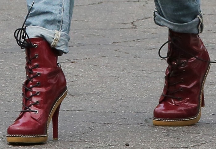 A splash of oxblood red: Gwen Stefani elevates her grunge attire with chic stiletto boots