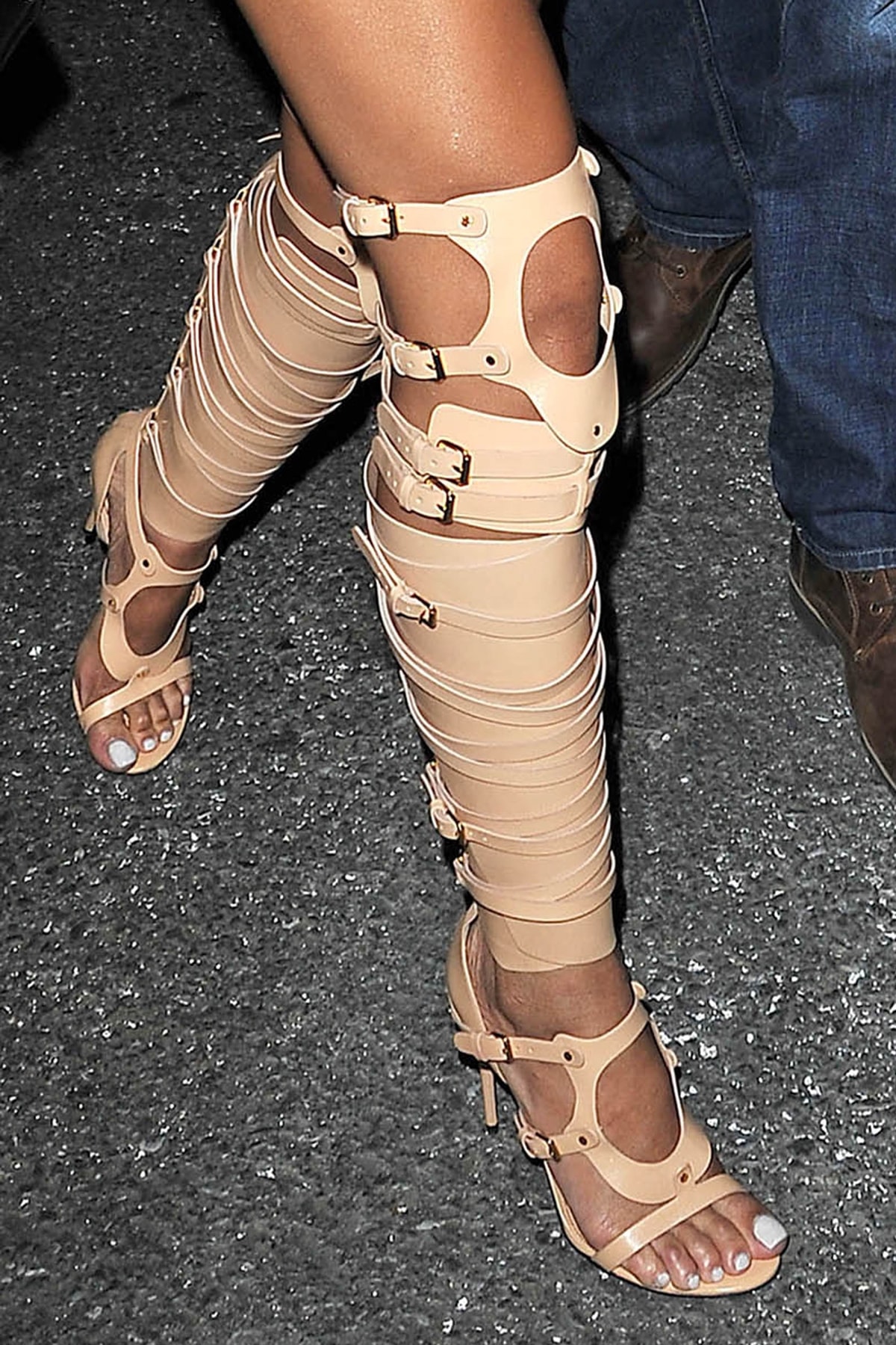 Rihanna's bold, thigh-high, bondage-inspired boots not only made a statement but also accentuated the pop star's enviable legs