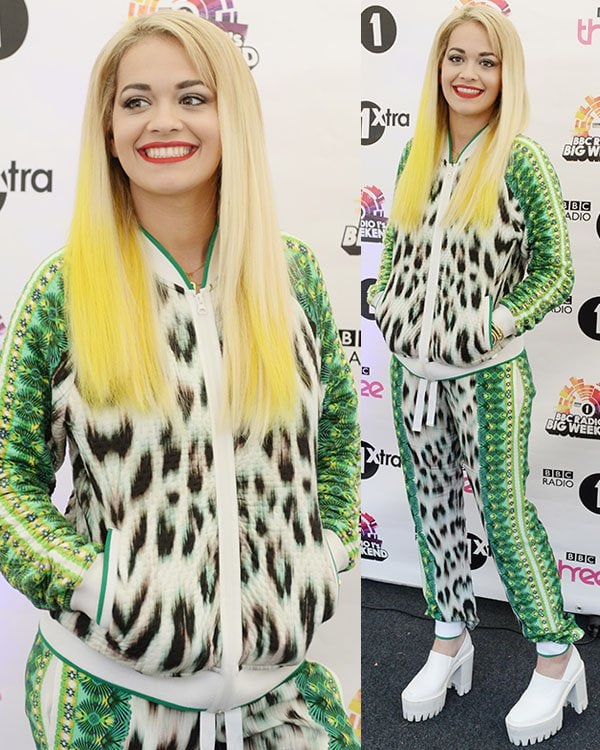 Rita Ora backstage in a printed jacket and matching pants by Roberto Cavalli
