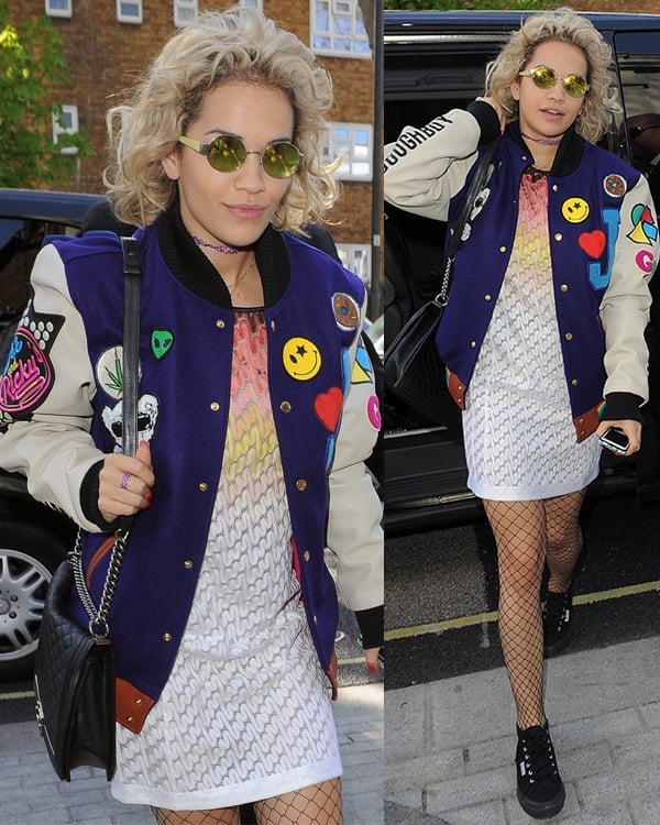Rita Ora showcases her unique androgynous style with a vibrant varsity jacket over a Missoni ombre knit dress