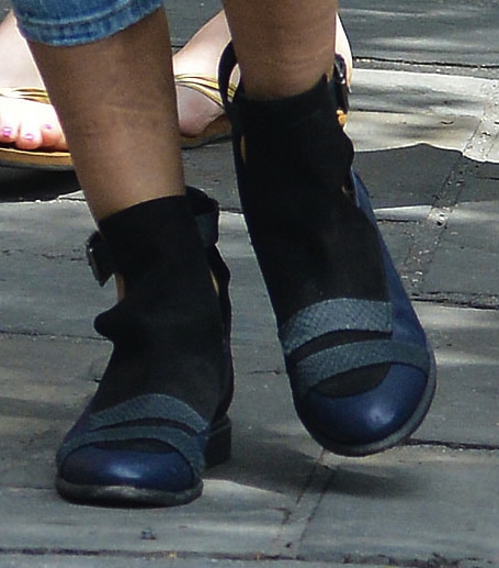 Close-up of Sarah Jessica Parker's stylish booties featuring a unique mix of blue, black, and snakeskin textures