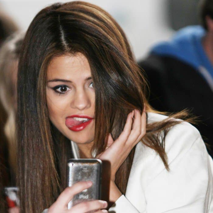 Selena Gomez proving even goofy faces can be glamorous—tongue out, style still intact!