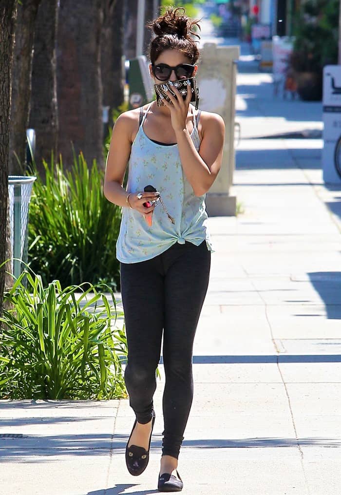 Vanessa Hudgens steps out in casual workout gear, pairing her laid-back tank top and leggings with playful black loafers featuring cute cat-face detailing
