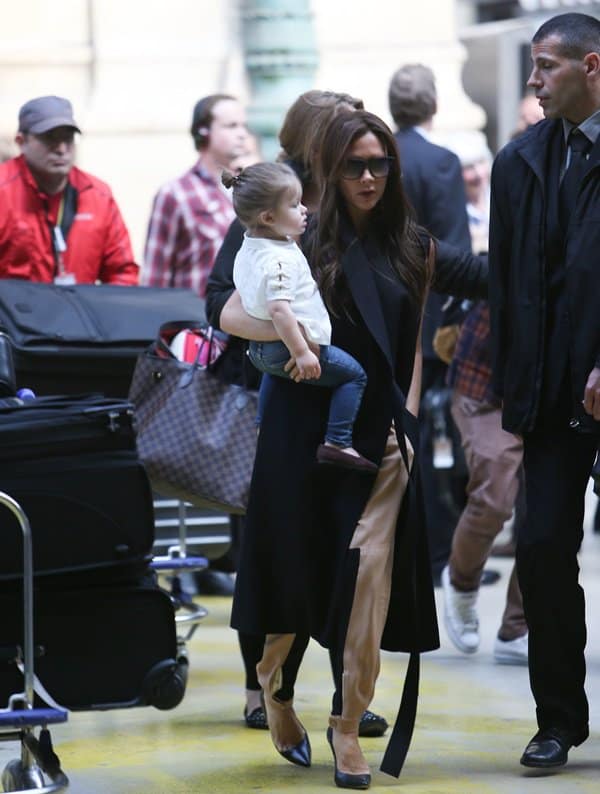 On May 2, 2013, at the Eurostar Station in Paris, Victoria Beckham looked effortlessly chic in a black coat from her Fall 2013 collection, paired with Chloe paneled crepe tapered pants and Manolo Blahnik BB pointy toe pumps