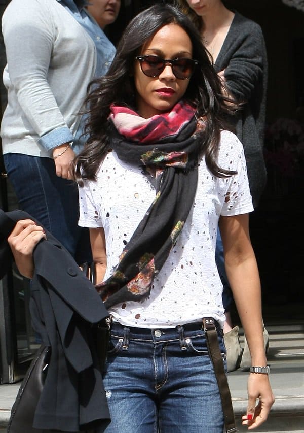 Zoe Saldana wears a wrap-around scarf outside the Corinthia Hotel in London