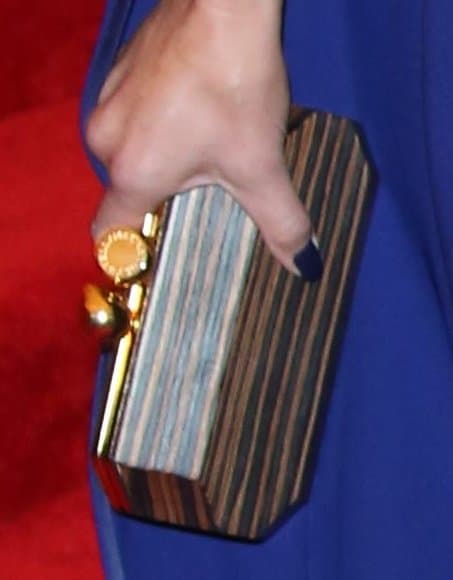 Cameron Diaz carried a wood-like clutch with gold trim, adding a rustic yet elegant touch to her outfit