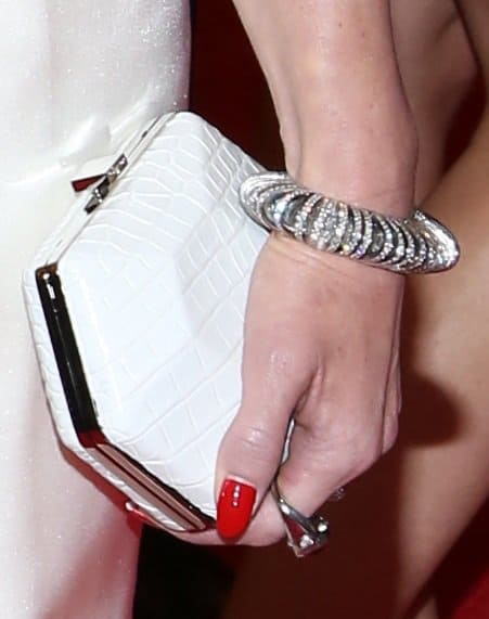 Gwen Stefani complemented her stylish gown with a white croc-embossed clutch