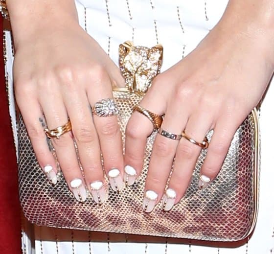 Rita Ora's look was punctuated by an eye-catching purse that, along with her vibrant nails, brought a touch of glamour and flair to her ensemble