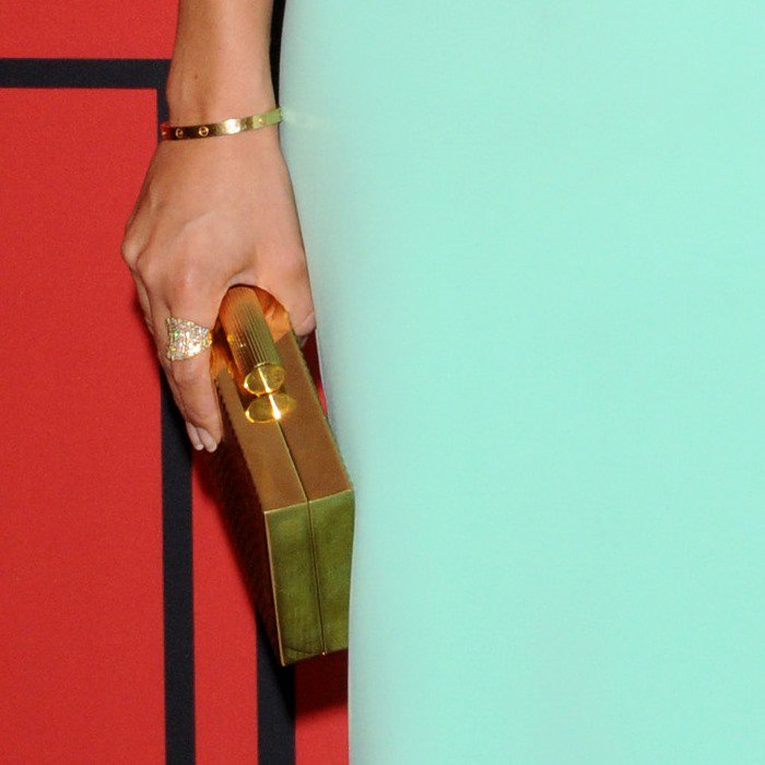 Ashley Madekwe shows off her gold Charlotte Olympia clutch and Cartier "Love" bracelet at the 2013 CFDA Fashion Awards