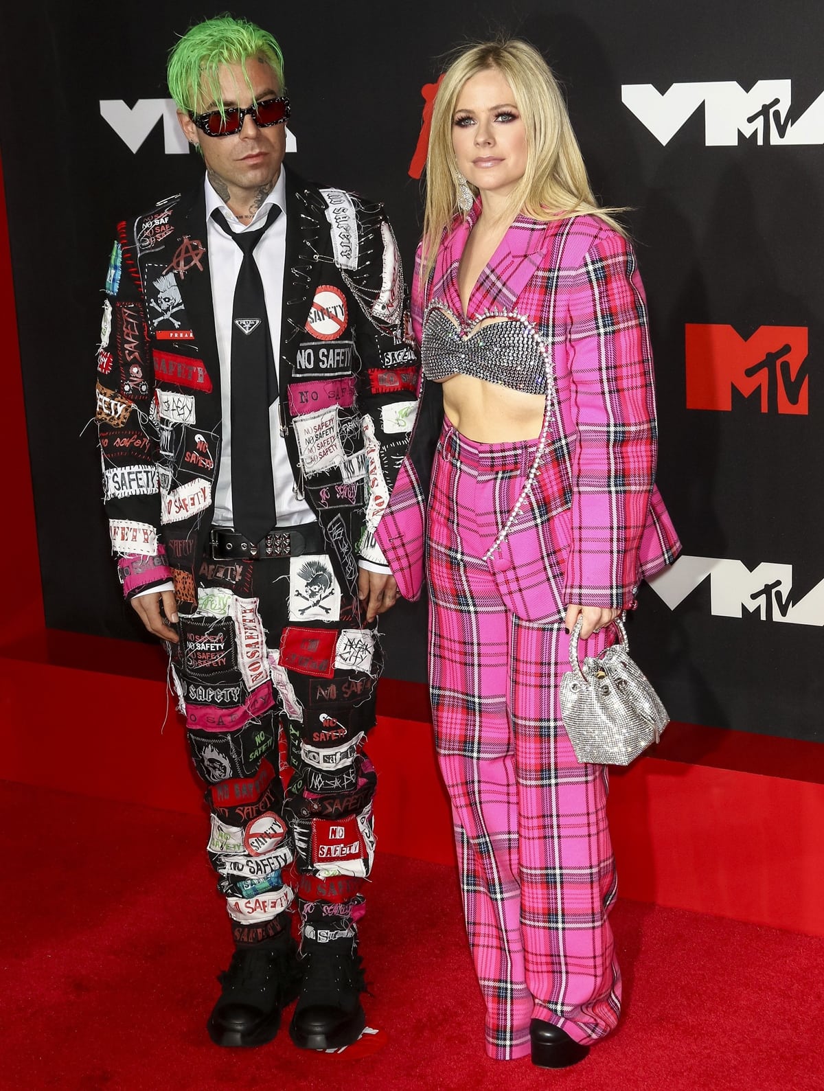 Avril Lavigne rocks a bright pink Area Pre-Fall 2021 suit with her boyfriend Mod Sun at the 2021 MTV Video Music Awards