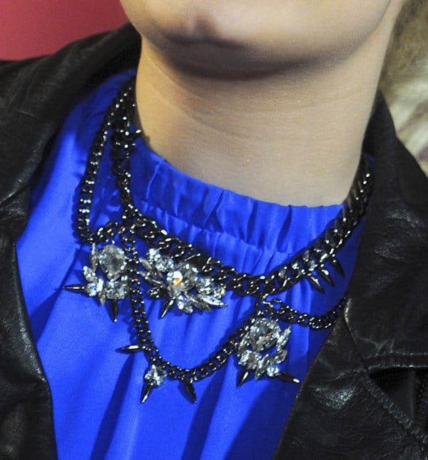 A close-up of Demi Lovato's striking Fallon necklace featuring chunky black chains and sparkling crystal embellishments